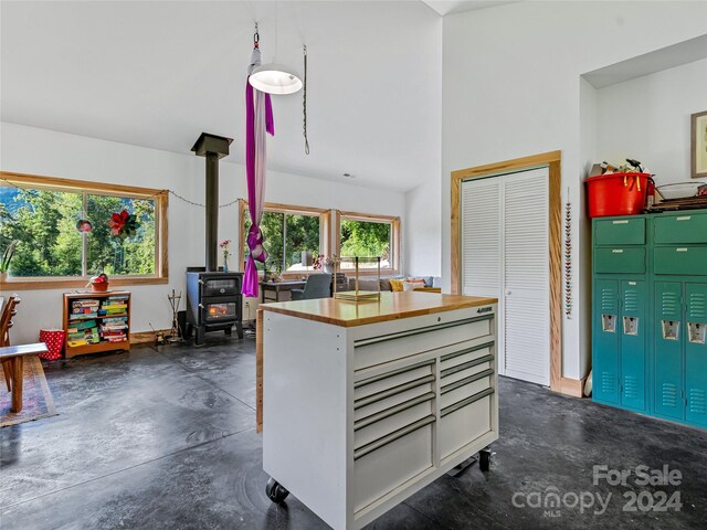 kitchen featuring white cabinetry and a wood stove