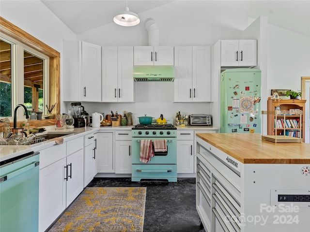 kitchen with gas range oven, white cabinets, butcher block counters, lofted ceiling, and dishwasher