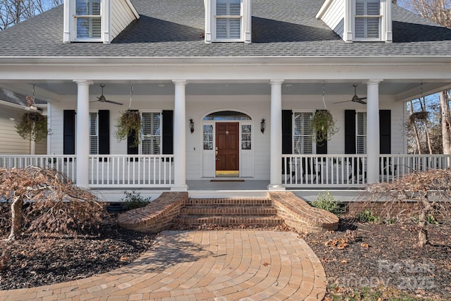 view of front of house with ceiling fan and a porch