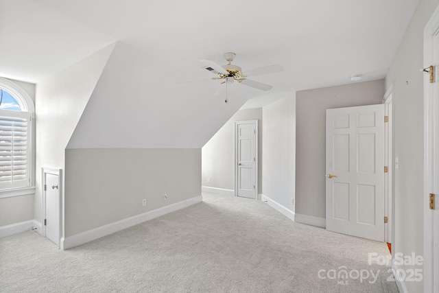 bonus room featuring lofted ceiling, light colored carpet, and ceiling fan