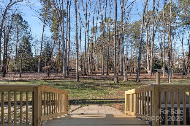 wooden terrace featuring a yard