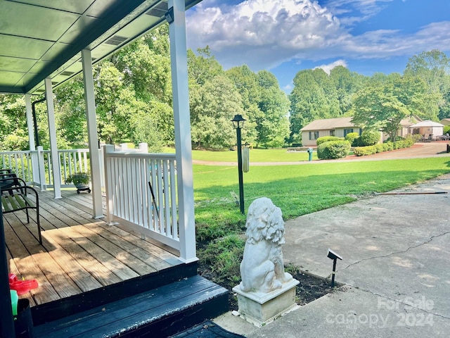 deck featuring a yard and covered porch