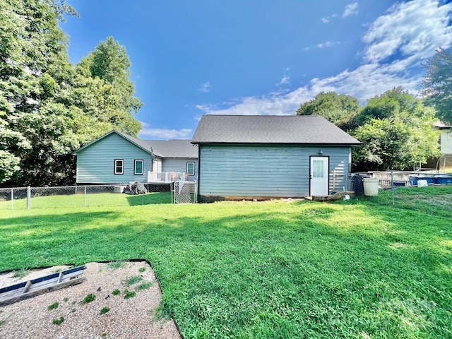 back of house with a lawn