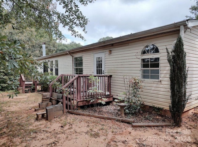 back of property featuring a wooden deck