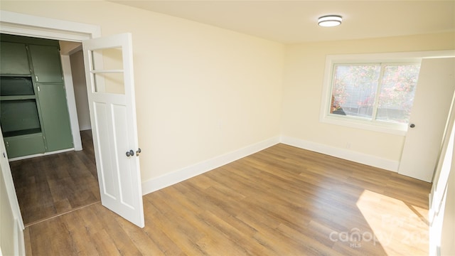 spare room featuring hardwood / wood-style floors