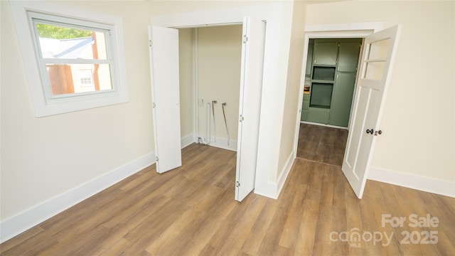 corridor with light wood-type flooring