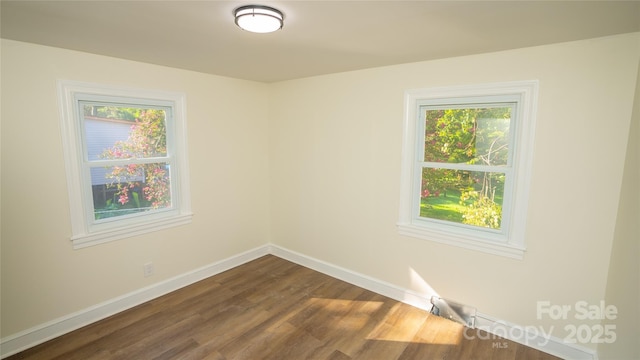 spare room with dark wood-type flooring