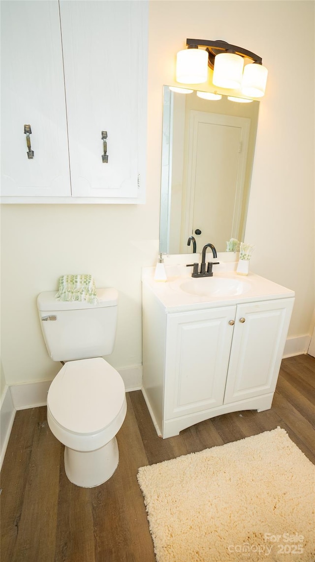 bathroom featuring hardwood / wood-style floors, vanity, and toilet