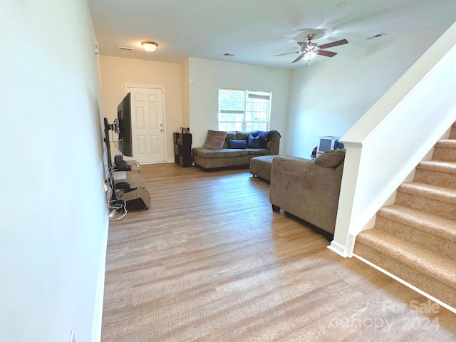 living room featuring light hardwood / wood-style floors and ceiling fan