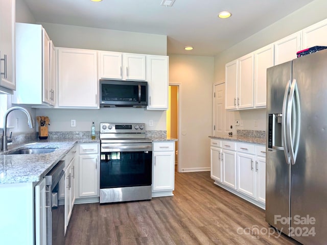 kitchen featuring sink, white cabinets, hardwood / wood-style flooring, and stainless steel appliances