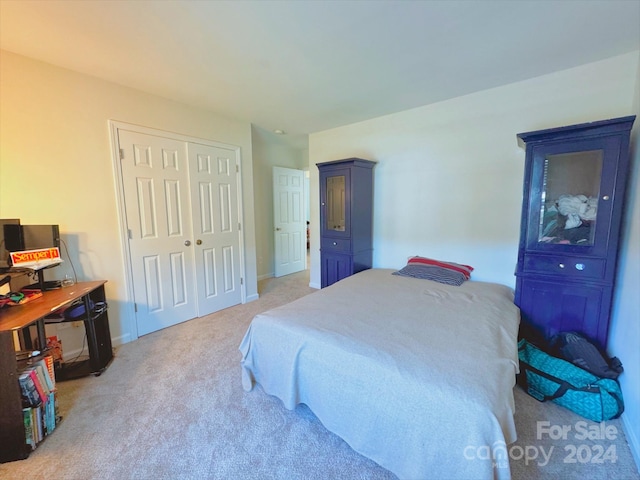 bedroom with light carpet and a closet