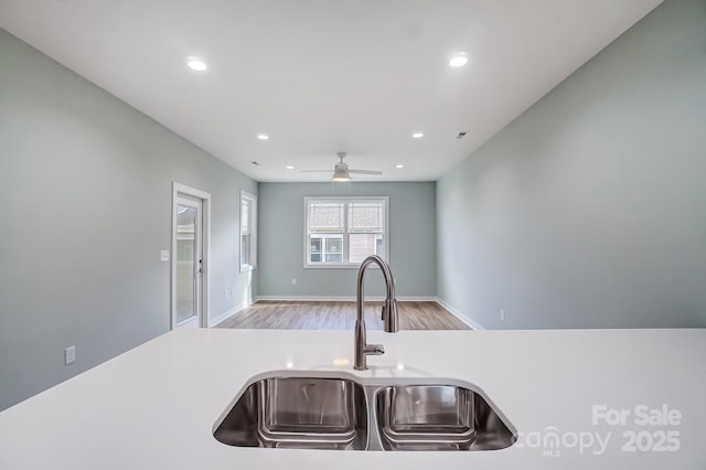 kitchen featuring sink, ceiling fan, and light hardwood / wood-style floors