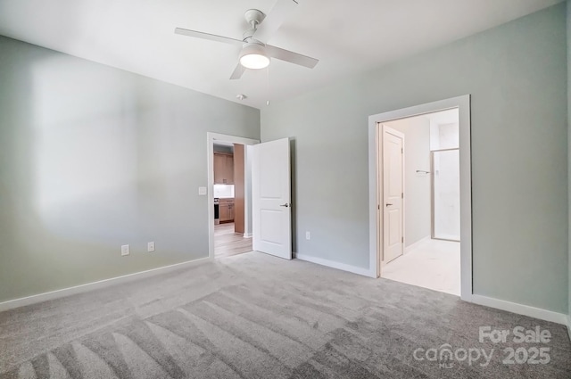 unfurnished bedroom featuring light carpet, ensuite bathroom, and ceiling fan