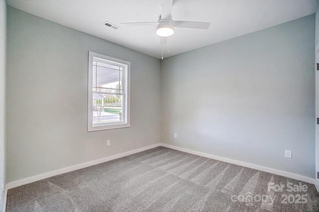 carpeted spare room with ceiling fan