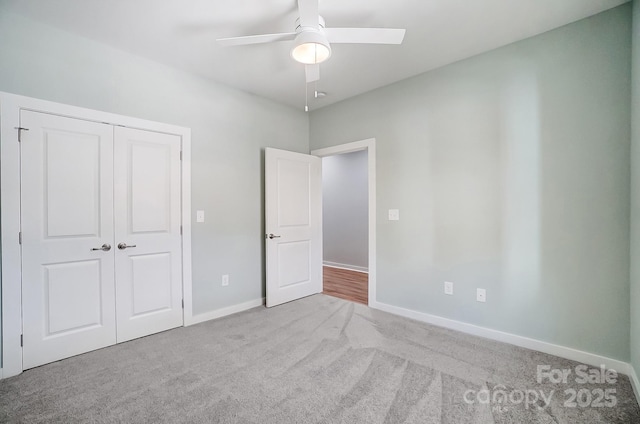 unfurnished bedroom with light colored carpet, a closet, and ceiling fan