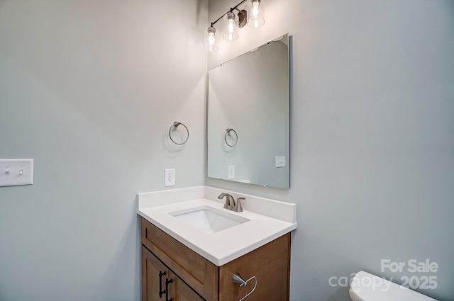 bathroom with toilet and vanity