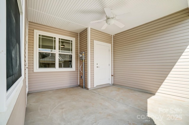 entrance to property featuring ceiling fan and a patio area