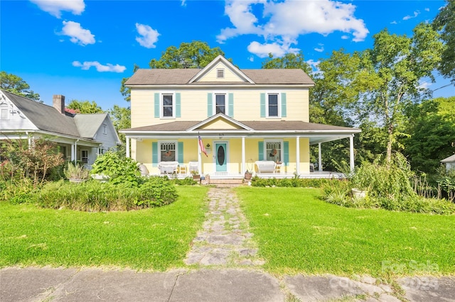 view of front of property with a porch and a front yard