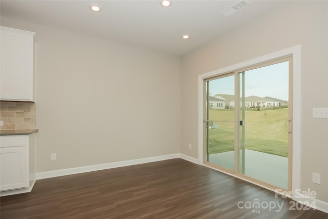 unfurnished dining area featuring dark hardwood / wood-style floors