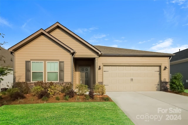 single story home with a garage and a front yard