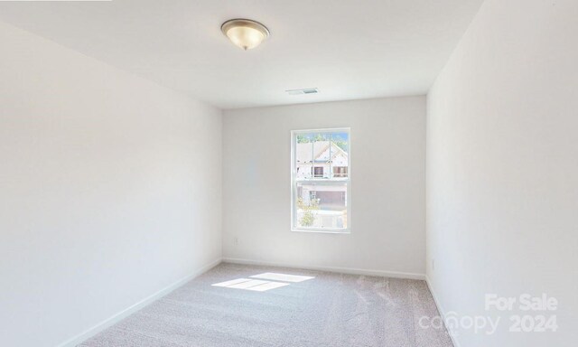 unfurnished room with light carpet