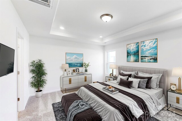 bedroom with a tray ceiling and light carpet