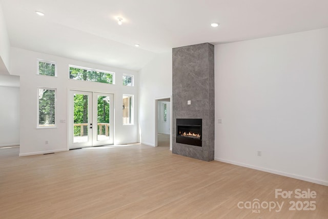 654 Hollybrook Dr, Flat Rock, NC 28731 - unfurnished living room featuring light wood-style flooring, high vaulted ceiling, a fireplace, and recessed lighting
