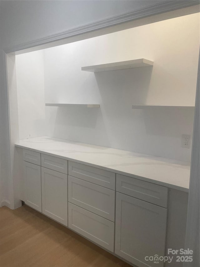 654 Hollybrook Dr, Flat Rock, NC 28731 - kitchen with open shelves, gray cabinets, light wood finished floors, and light stone countertops