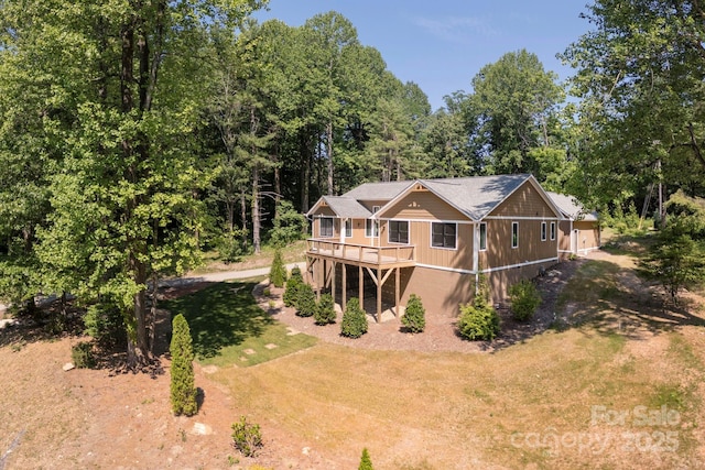 654 Hollybrook Dr, Flat Rock, NC 28731 - back of house with a wooden deck, driveway, and a lawn
