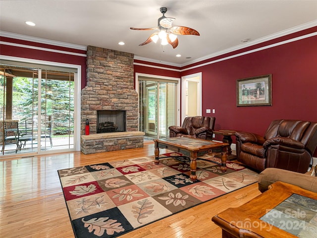 living room featuring ceiling fan, crown molding, light hardwood / wood-style flooring, and a wealth of natural light