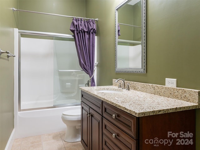 full bathroom featuring shower / bath combination with glass door, vanity, tile patterned floors, and toilet