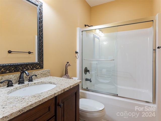 full bathroom featuring bath / shower combo with glass door, toilet, and vanity