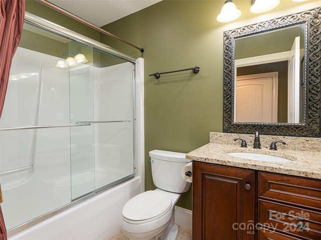 full bathroom featuring vanity, enclosed tub / shower combo, toilet, a textured ceiling, and tile patterned flooring