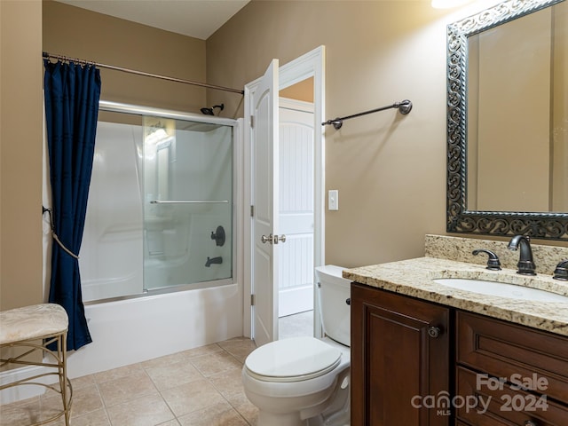 full bathroom featuring vanity, toilet, tile patterned floors, and enclosed tub / shower combo