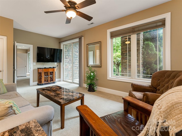 living room with light carpet and ceiling fan