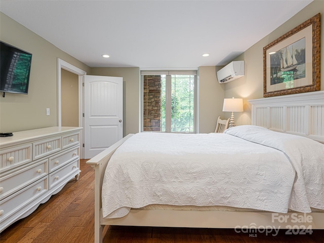 bedroom featuring a wall mounted AC and dark hardwood / wood-style flooring