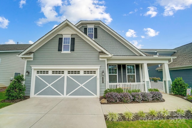 craftsman-style house featuring a porch and a garage