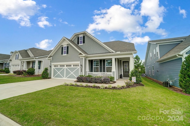 craftsman-style home featuring a garage and a front lawn