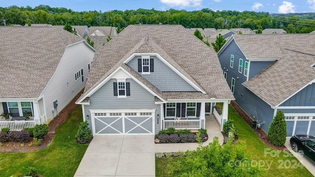 craftsman inspired home featuring a garage and central AC