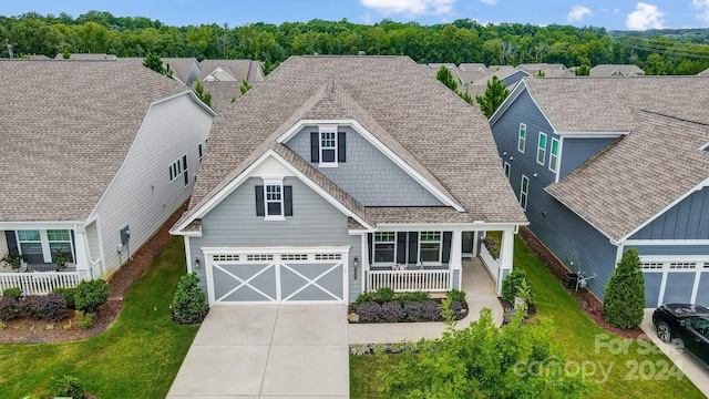 craftsman house with a garage and covered porch