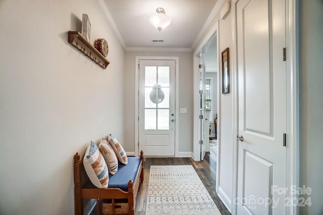 doorway to outside with crown molding and dark hardwood / wood-style floors