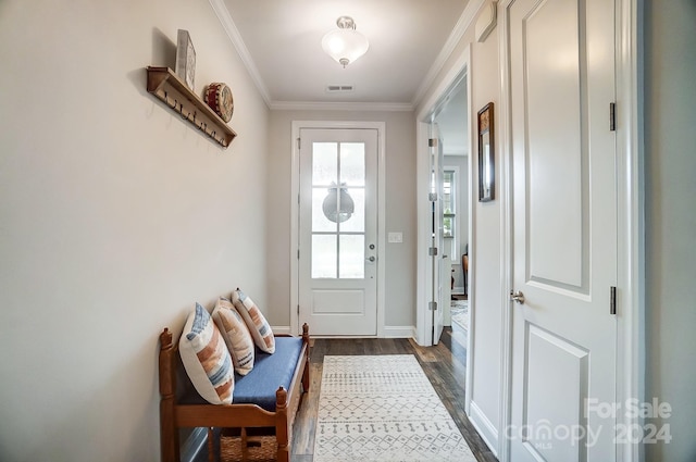 doorway featuring ornamental molding and dark hardwood / wood-style floors