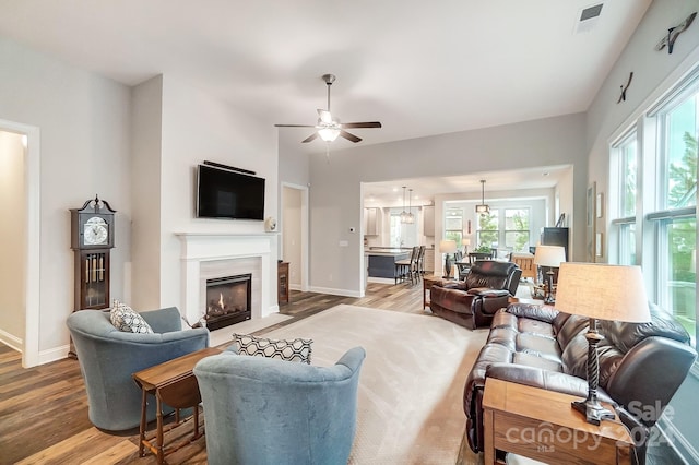 living room featuring hardwood / wood-style floors and ceiling fan