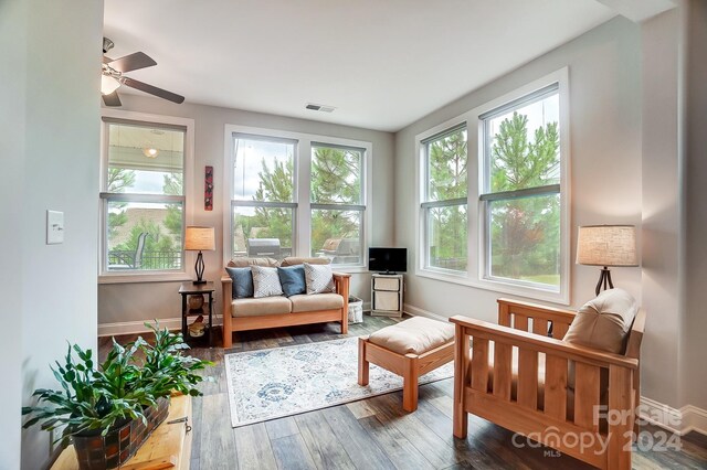 sunroom / solarium featuring a wealth of natural light and ceiling fan