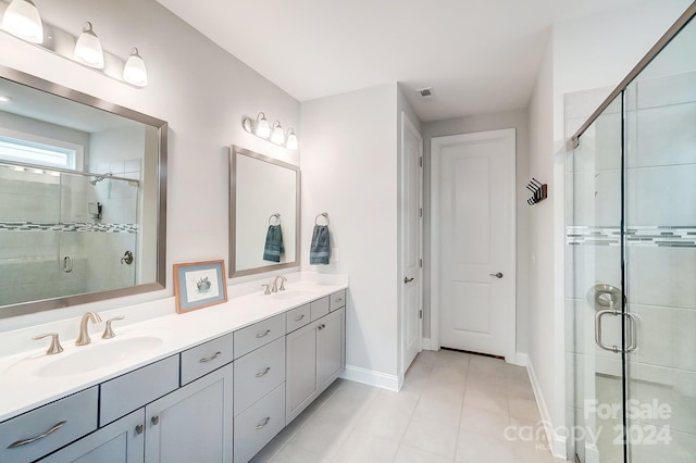 bathroom with vanity, tile patterned flooring, and walk in shower