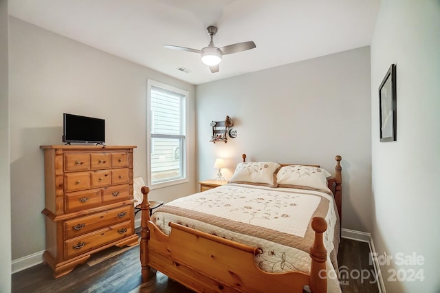 bedroom with dark hardwood / wood-style floors and ceiling fan