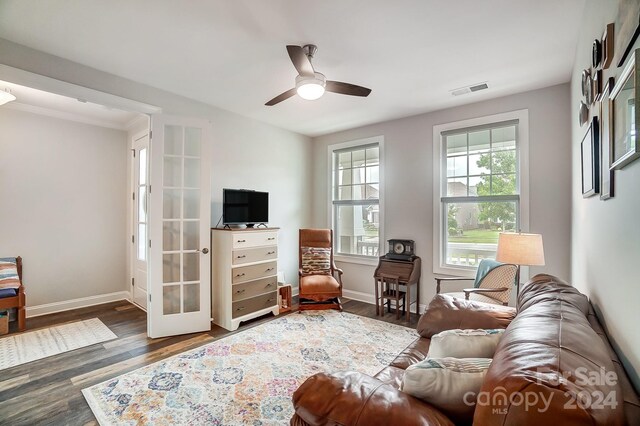 living room with dark hardwood / wood-style floors, ceiling fan, and french doors