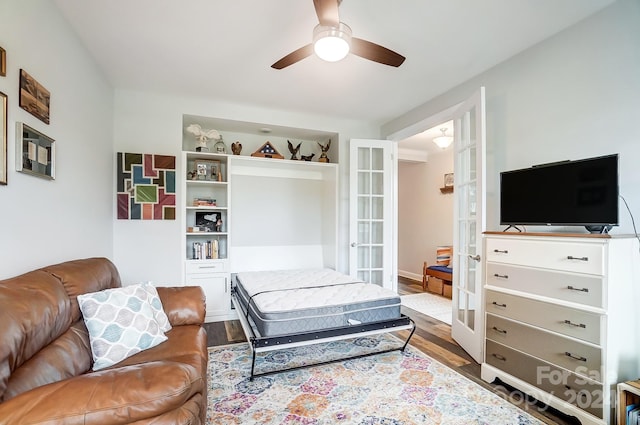 living room with hardwood / wood-style flooring, french doors, and ceiling fan