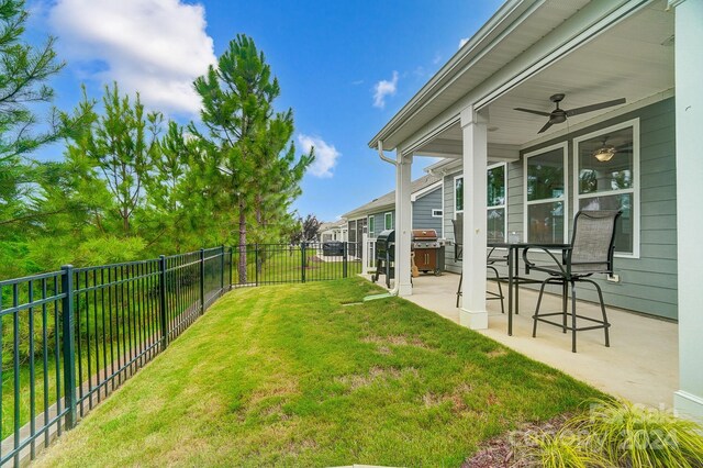 view of yard with a patio area and ceiling fan