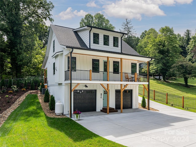 view of front of home featuring a garage, central AC, and a front yard